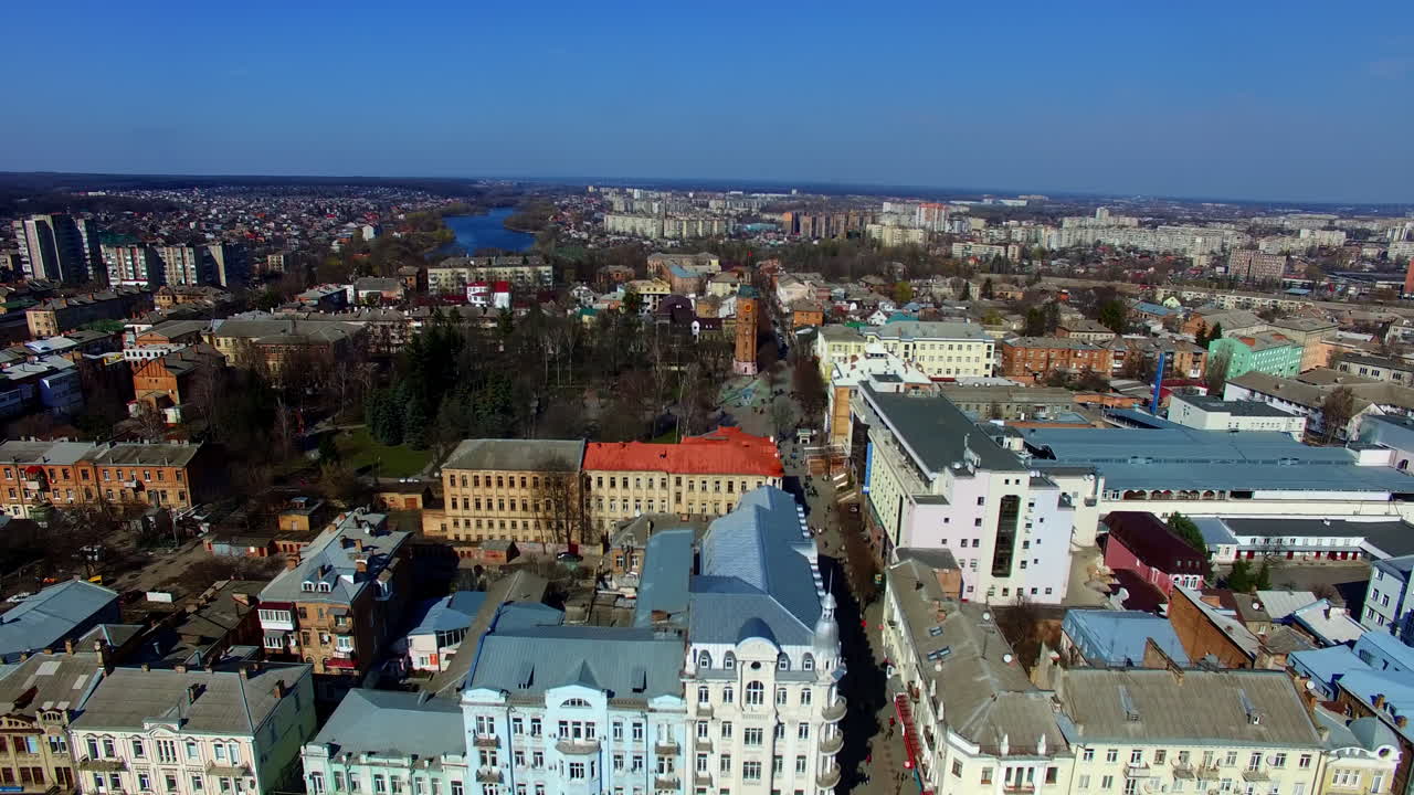 Vast scenery of the Ukrainian city on sunny autumn daytime. Top view of the cityscape divided by the river.