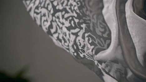 close-up video of flowing fabric with intricate patterns, captured from a low angle