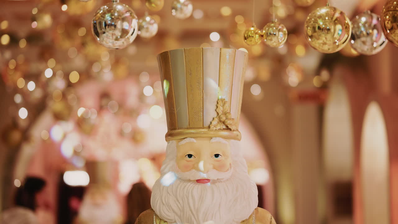 Close up of a Santa Claus figure inside a festive Christmas installation with warm lights and ornaments