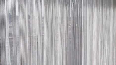 closeup of white string curtains