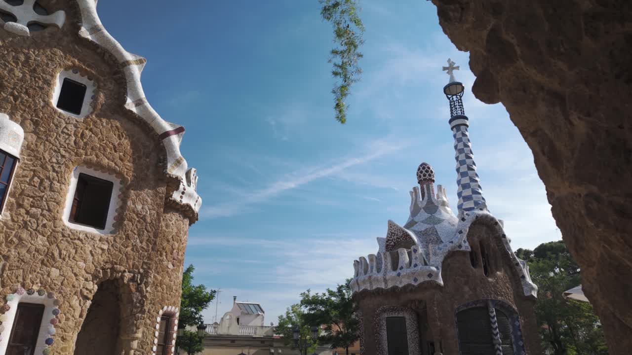Establishing tilt down along main Park Güell building with its colorful mosaics and unique tesselated building, pan right