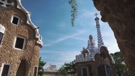 establishing tilt down along main park güell building with its colorful mosaics and unique tesselated building, pan right