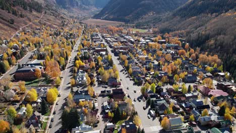 pullback drone shot over main street in telluride, co with fall colors