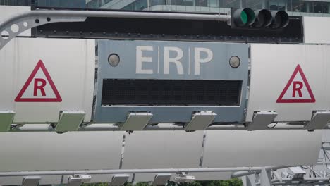 an erp (electronic road pricing) gantry with a green traffic light in singapore