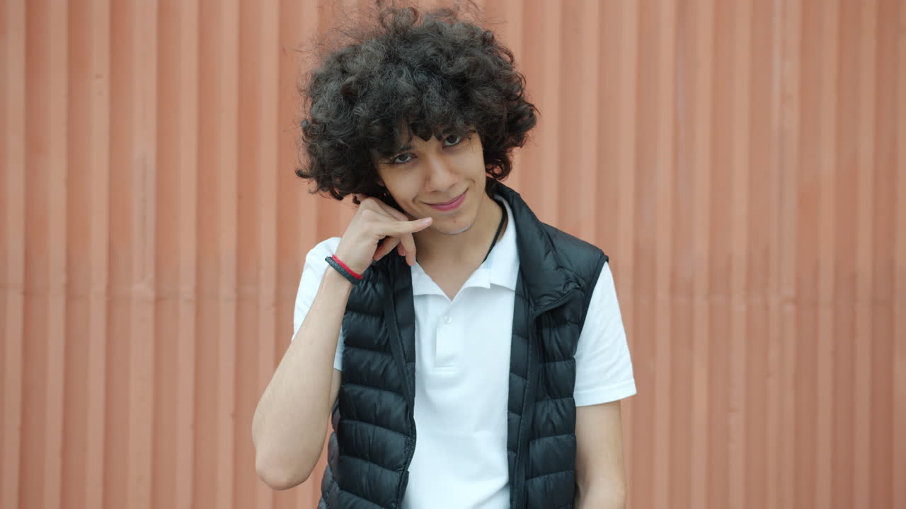 Teenage boy posing outside