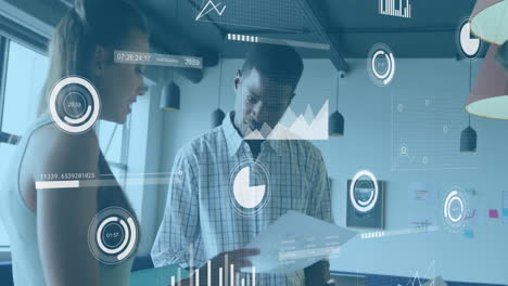 animation of data processing against diverse man and woman discussing over document at office