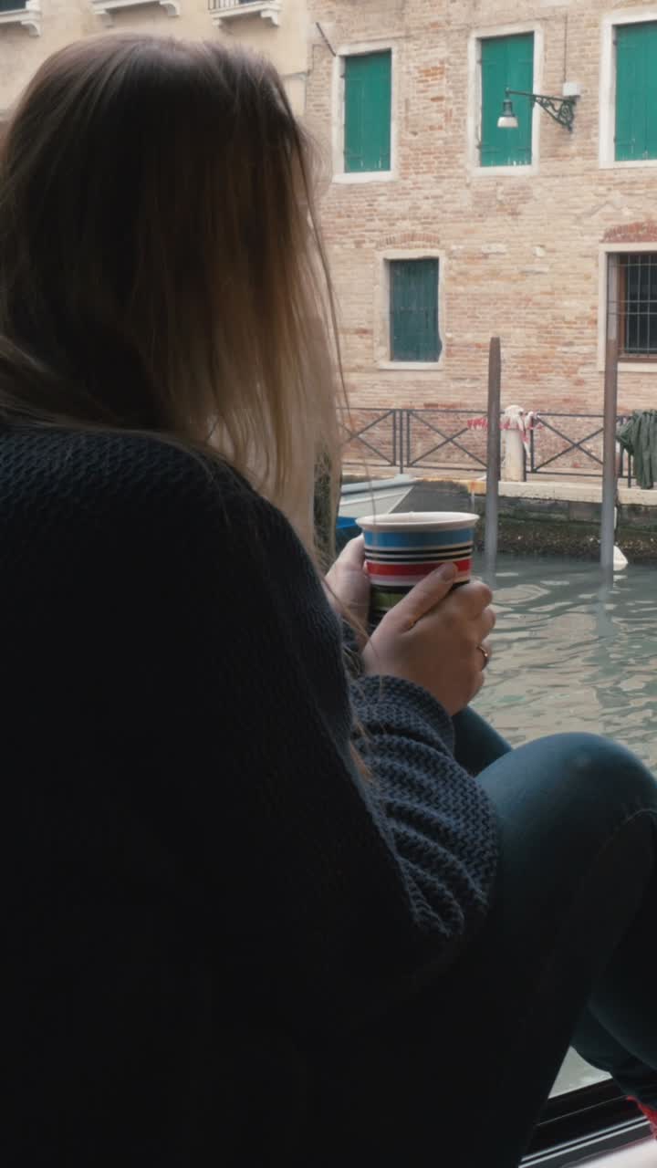 Woman enjoying coffee in Venice