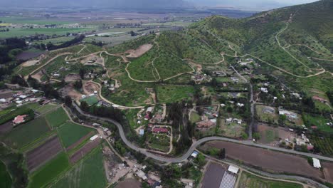 rural fields, winding path on the mountain near the pomaire town in chile