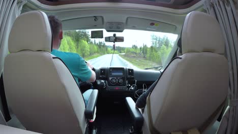 man driving on a road in the camper van rv