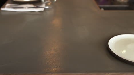 empty place setting at a restaurant bar, camera slider shot