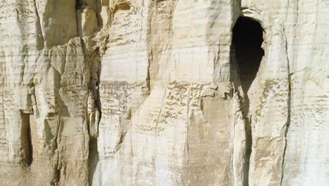 layered rock face with cave