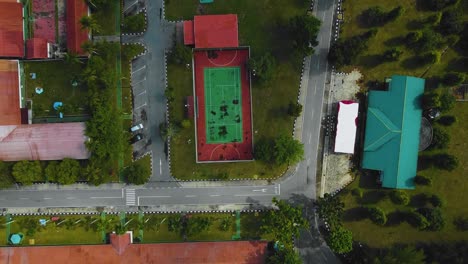 Cinematic-Drone-Footage-of-Palm-Oil-Mill-Effluent-residential-consists-of-buildings,-homes,-main-road-and-infrastructure-surrounded-by-palm-oil-trees-deforestation-located-in-Indonesia-in-full-HD