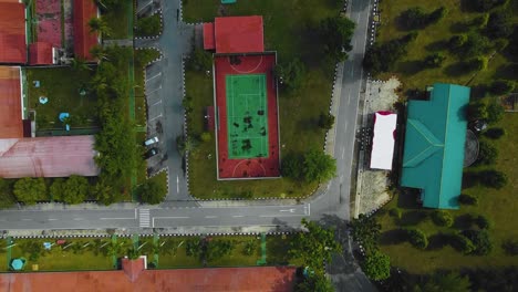 cinematic drone footage of palm oil mill effluent residential consists of buildings, homes, main road and infrastructure surrounded by palm oil trees deforestation located in indonesia in full hd