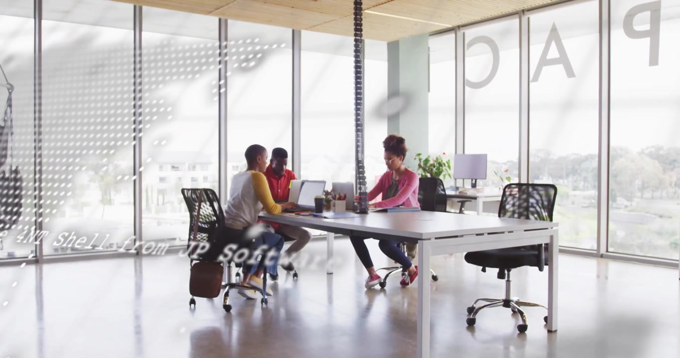 Digital overlay fading and revealing colleagues collaborating in tech office with laptops and notes