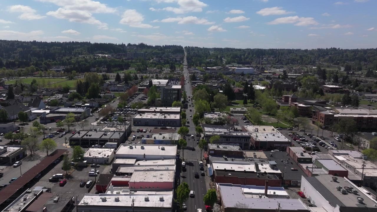 Dense Urban Development With Rooftops, Roads, And Parked Vehicles In Puyallup, Washington, USA - Drone Shot