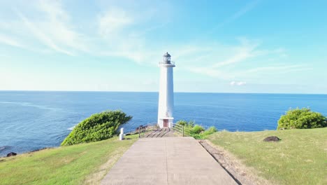 Lighthouse-of-Vieux-Fort-on-sunny-summer-day-in-Guadeloupe,-aerial-pedestal-up-shot