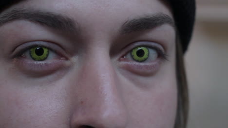 a man opens his eyes to reveal creepy spooky green eyes staring