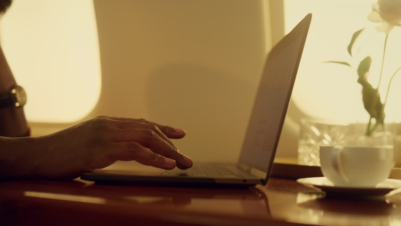 Closeup business graphs laptop at airplane. Successful analyst hands type data