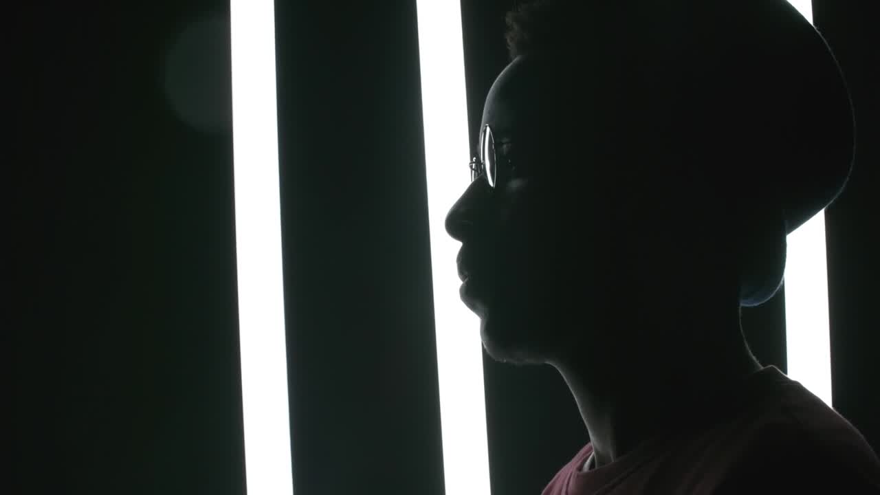 Silhouette of Man Posing in Dark Studio