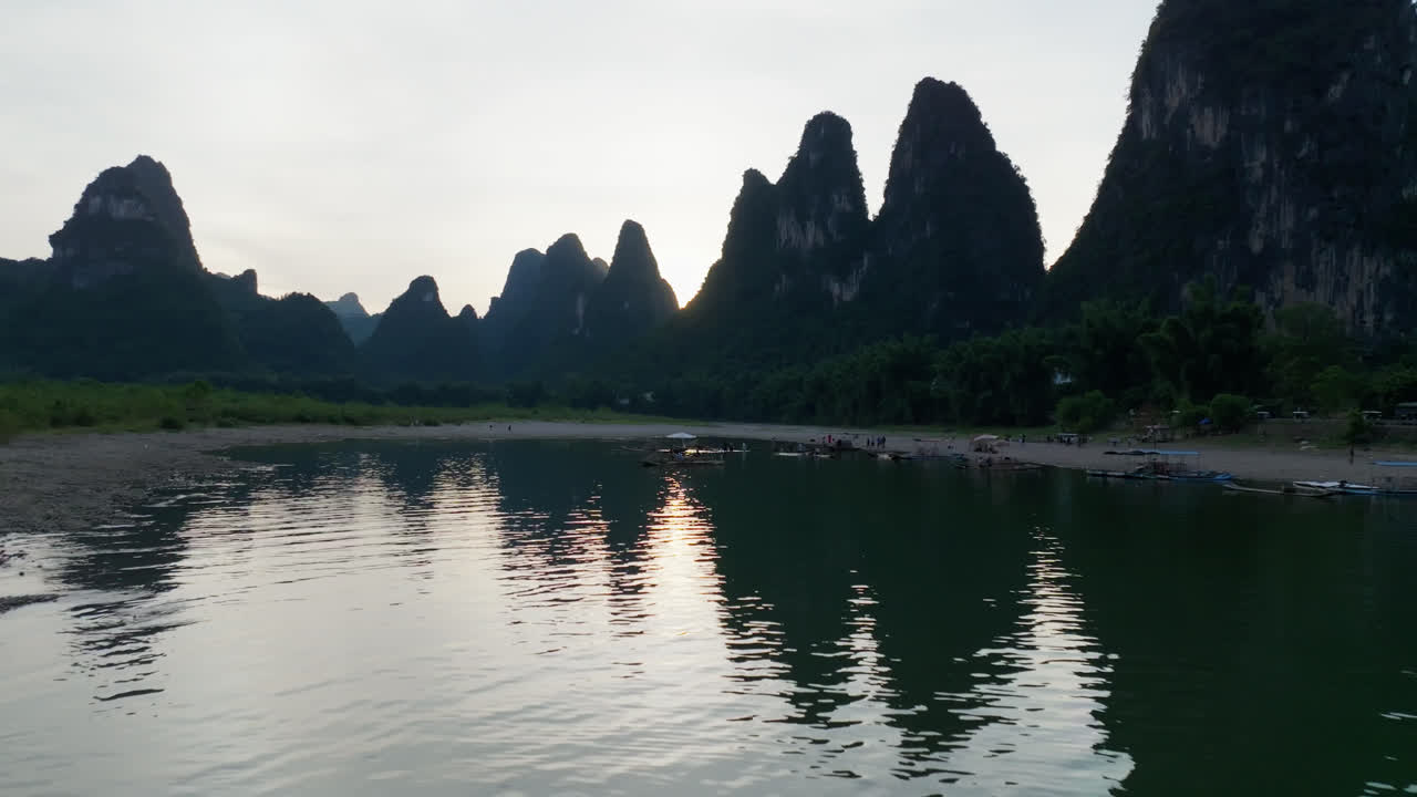 Aerial view of tourists taking pictures of fishermen on rafts in Xingping, China