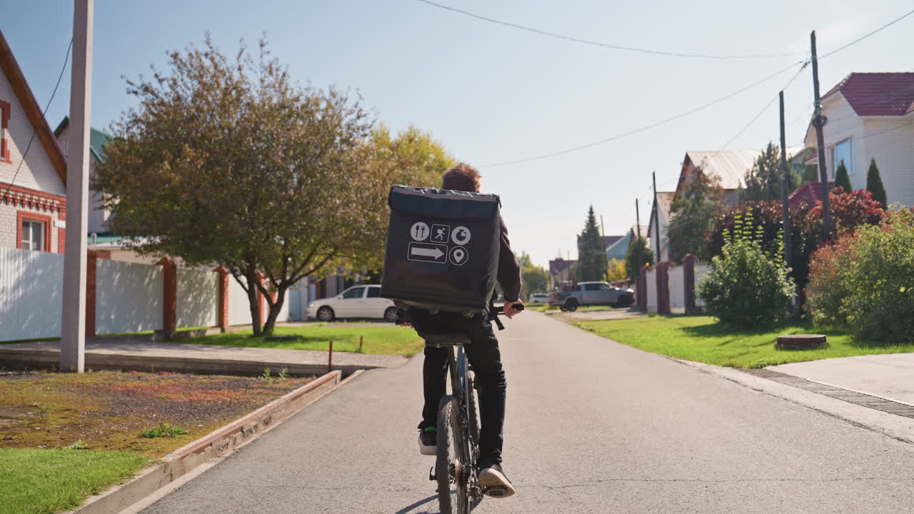 courier pedaling through treelined suburban street, riding electricassisted bicycle with insulated delivery box, passing houses with gardens and trimmed hedges, bright morning light, swift confident