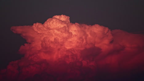 time-lapse of vibrant, red sunset clouds building on the sunlit evening sky