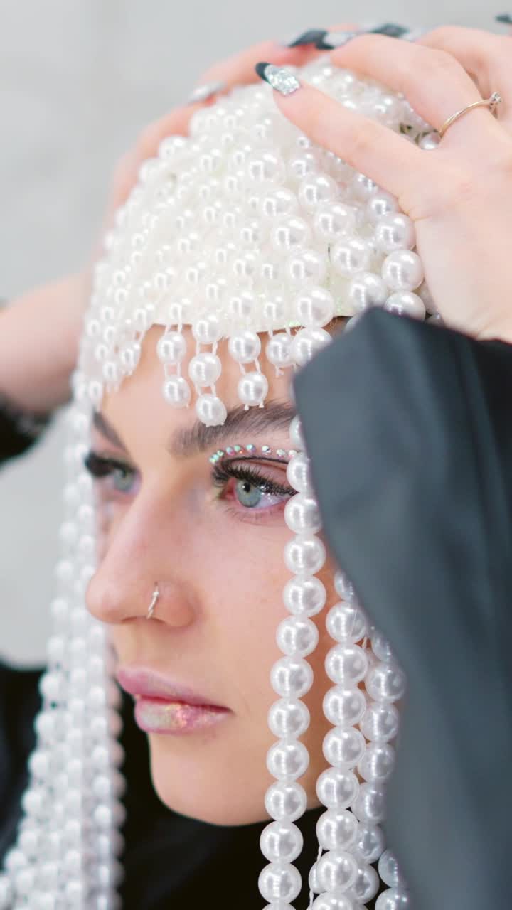 Woman with Elaborate Pearl Headpiece and Rhinestone Eye Makeup