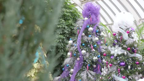 decorated purple and white christmas tree with festive ornaments