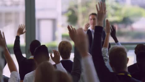 business professionals raising their hands in a business seminar 4k