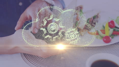 cloud computing animation over person holding smartphone near food on table