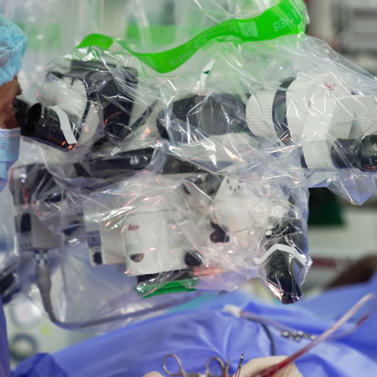 Professional doctor looking intently into equipment binoculars. Surgeons stare at microscope performing surgery