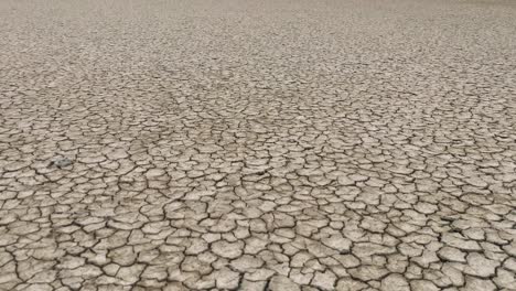 dried out lake bed, tilt up shot viewing landscape, thailand