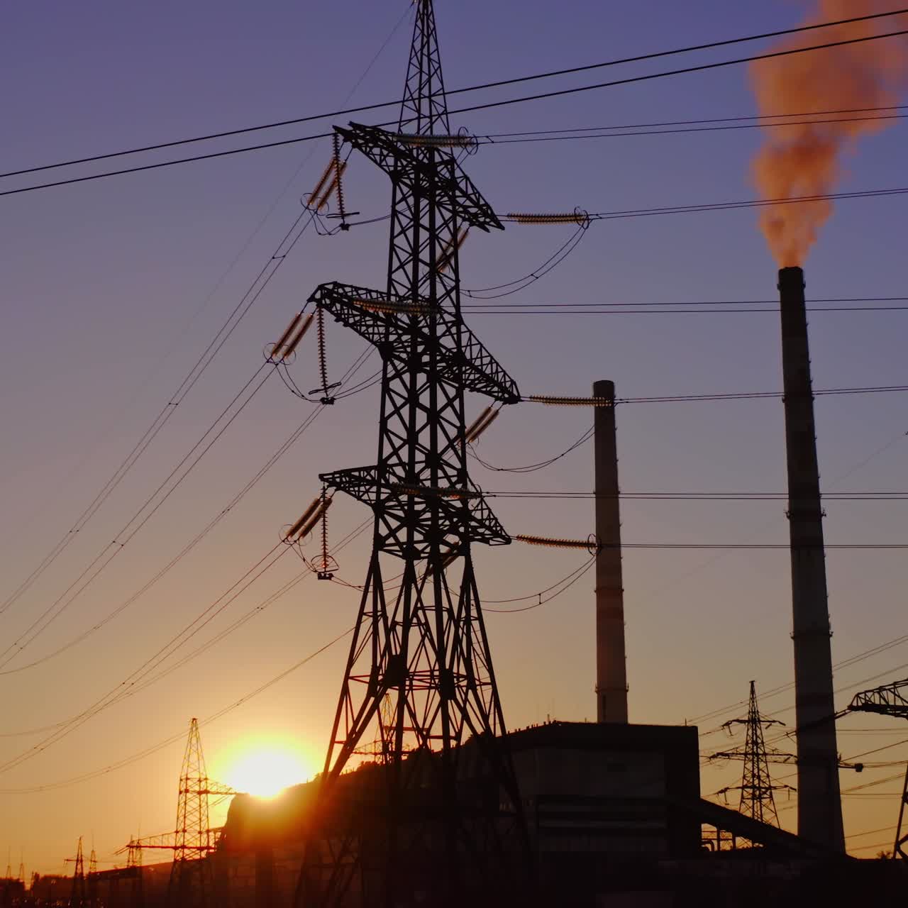 Electricity pylons and lines at dusk