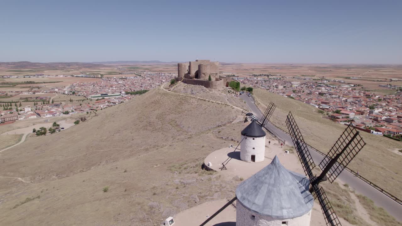 Spanish windmills and Consuegra Castle. La Mancha, Spain. Low-altitude aerial view and flyover of windmills