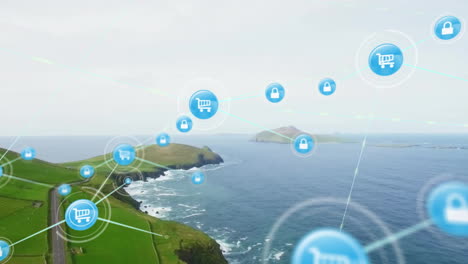 Animation-of-icons-connected-with-lines-over-aerial-view-of-green-landscape-and-sea-against-sky