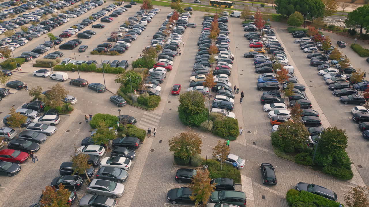 Aerial many cars parked on public city carpark. Automobiles riding large parking