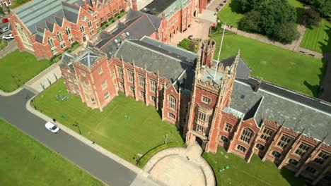 reversing and ascending aerial video of queen's university belfast, in northern ireland, uk on a bright and sunny day. produced at 4k resolution, 60fps and with rec709 color.
