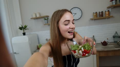 POV-shot-of-blogger-girl-making-photos,-taking-selfies-with-salad-for-social-media-on-mobile-phone