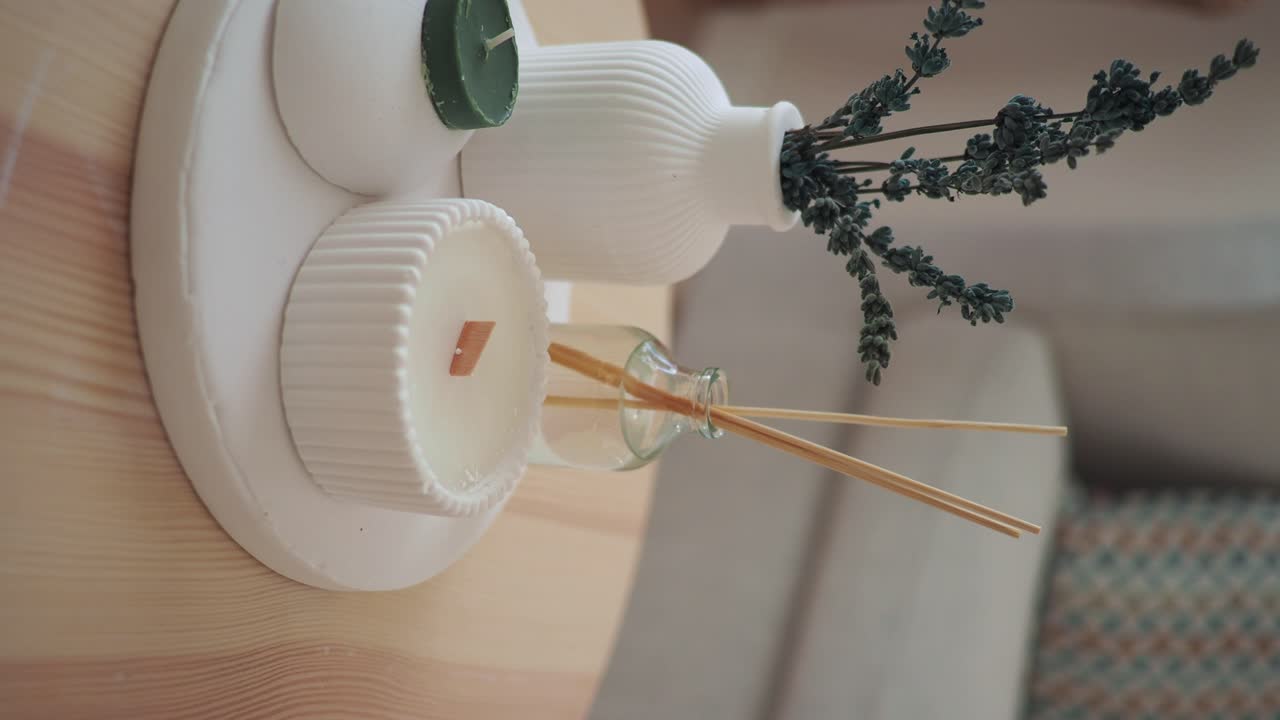 Still life with candle, diffuser, and lavender