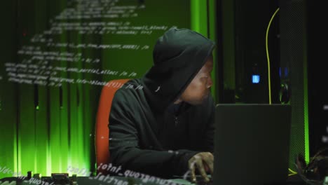Animation-of-data-processing-over-african-american-man-working-on-laptop-in-server-room
