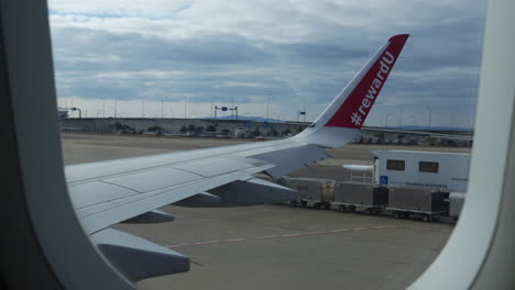 preparing for takeoff: a glimpse of airport personnel in action from the window of a plane