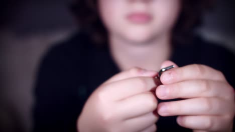 4k of child hands playing with metal puzzle for brain teaser