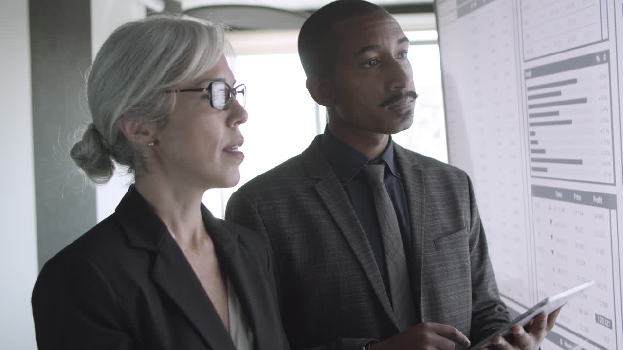 Female expert explaining financial charts to investor