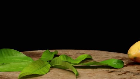 Fresh-mango-juice-is-poured-in-a-jug-next-to-the-wooden-box-full-of-mango-on-the-background-time-lapse-4k