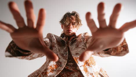 fashion model reaching out in slow motion on white background