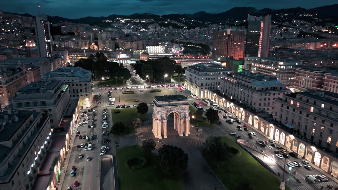 Night aerial view of Piazza della Vittoria with iconic illuminated Victory Arch
