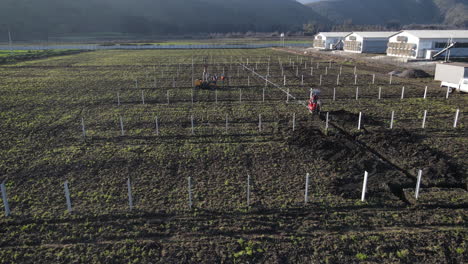 tractor in the process of working between the rows for solar panels