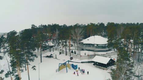 hotel among old pines at resort with ski tracks aerial view