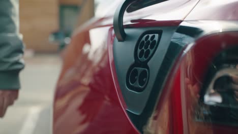 the car's charging port flap is opened in the parking lot