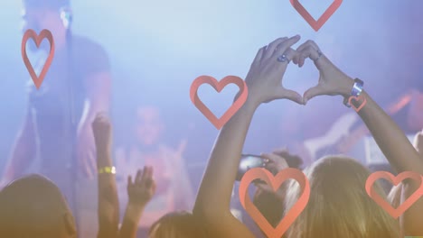 animation of heart icons over diverse people during concert